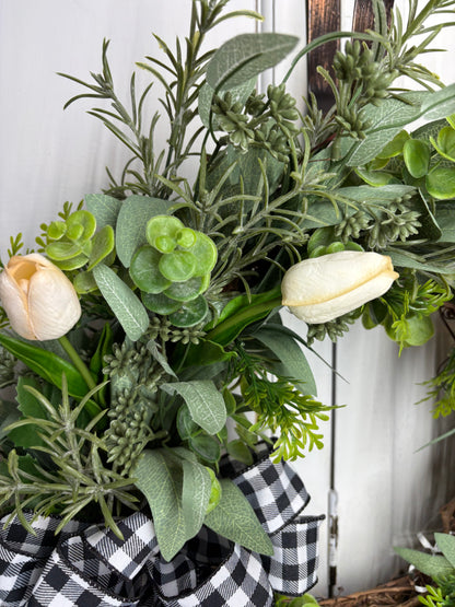 Spring tulip wreath featuring cream tulips, eucalyptus, and a black and white checkered bow on a grapevine base.