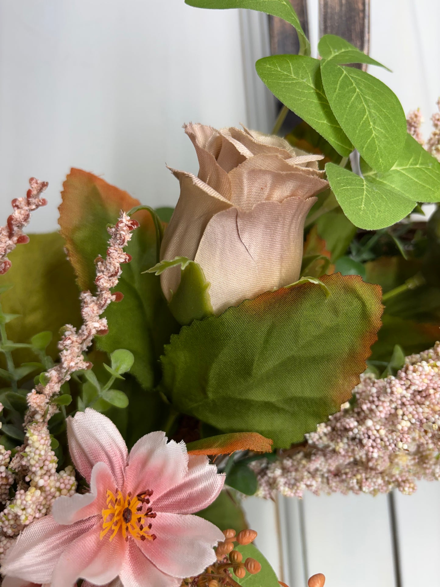 Spring peony and rose wreath featuring soft pink flowers and green leaves on an 18-inch grapevine base.