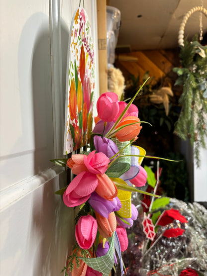 Spring tulip sign door hanger featuring narrow profile of colorful faux tulips in pink, purple, and orange with green accents.