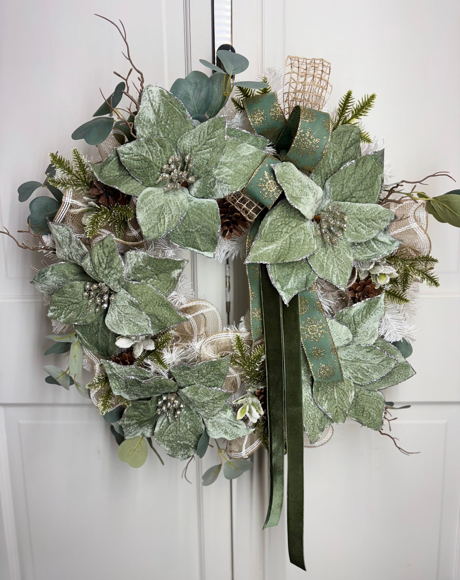 Winter mint wreath featuring a 24-inch white pine base, adorned with velvet poinsettias and green foliage.
